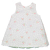 White dress with floral pattern, green ruffles and lace